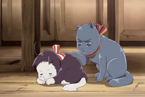 A Cat Scratching Another Cat 'S Back With A Red White And Blue Bow Around Its Neck GIF