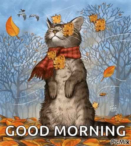 A Cat Wearing A Scarf And Leaves On Its Face With The Words Good Morning Written Below It . GIF