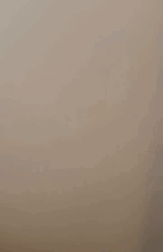 A Cell Phone Is Floating In The Air With A Picture Of A Person On The Screen . GIF