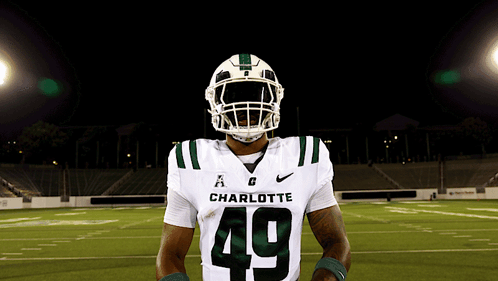 a charlotte football player wearing number 49 poses for a photo