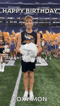 A Cheerleader Is Holding A Bunch Of Pom Poms On A Field . GIF