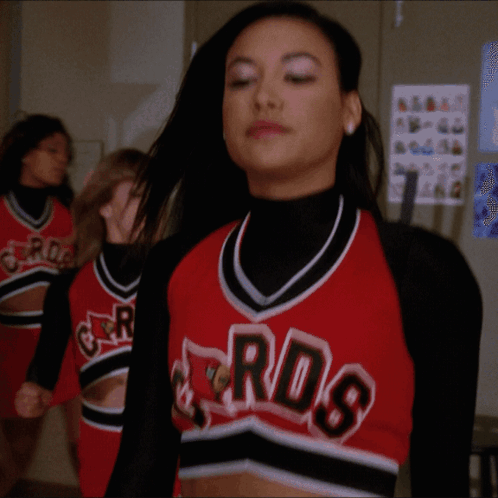 A Cheerleader Wearing A Red And Black Jersey With The Word Rds On It GIF