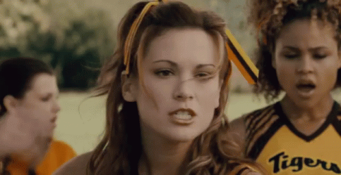 A Cheerleader Wearing A Yellow Tigers Jersey Looks Angry GIF