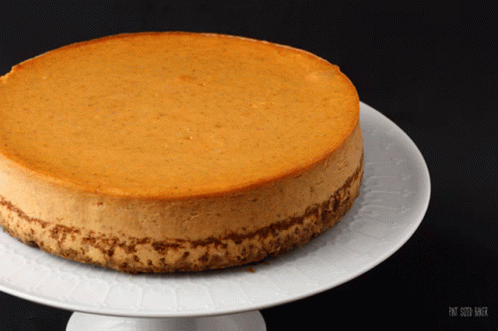 A Cheesecake On A White Plate That Says Pat Smith Baker On It GIF