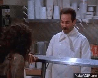 A Chef Is Talking To A Woman In A Kitchen . GIF