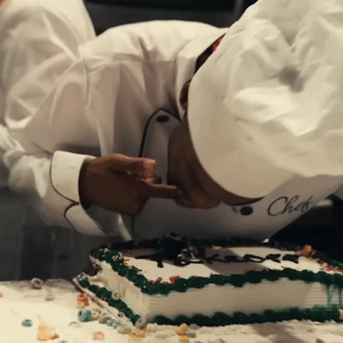 a chef wearing a white hat with the word chef written on it