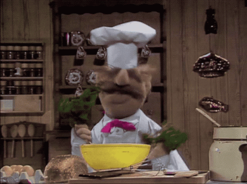 A Chef With A Mustache And A Pink Bow Tie Is Mixing Something In A Yellow Bowl GIF