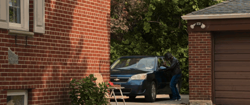A Chevrolet Car Is Parked In Front Of A House GIF