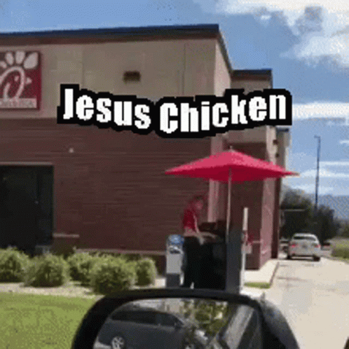 A Chick Fil A Restaurant With Jesus Chicken Written On The Side Of It GIF