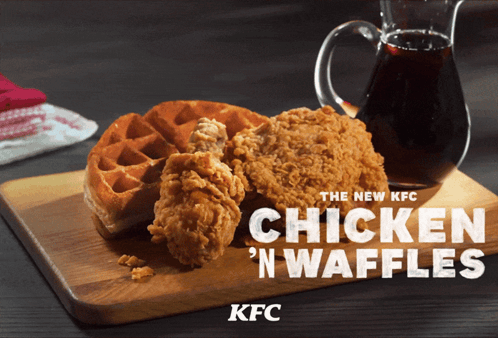 a chicken and waffle on a cutting board that says chicken n waffles