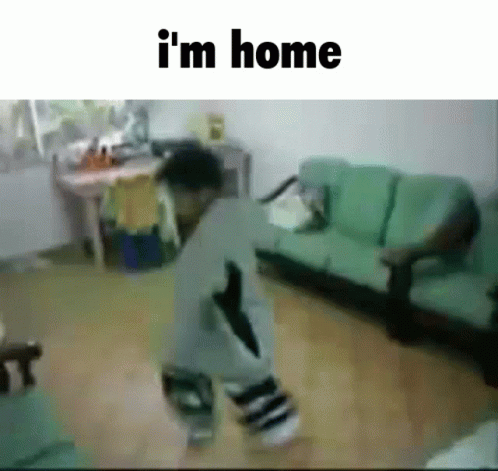 A Child Is Dancing In A Living Room With The Words " I 'M Home " Below Him GIF