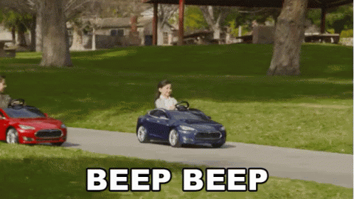 A Child Is Driving A Toy Car With The Words Beep Beep Written Below It GIF
