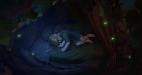 a child is sleeping under a tree with glowing green lights around