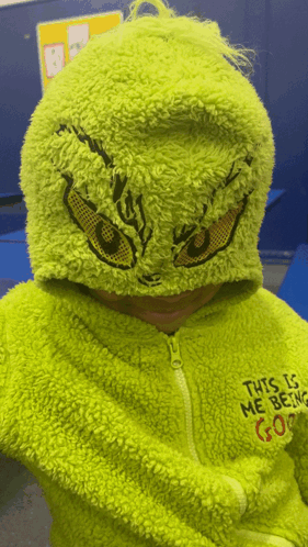 A Child Is Wearing A Grinch Costume With The Words This Is Me Being Gone On The Back GIF