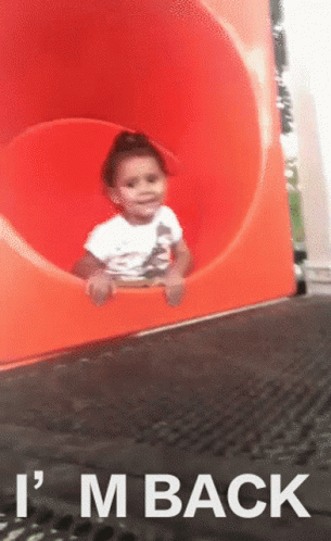 A Child On A Slide With The Words " I 'M Back " On The Bottom GIF