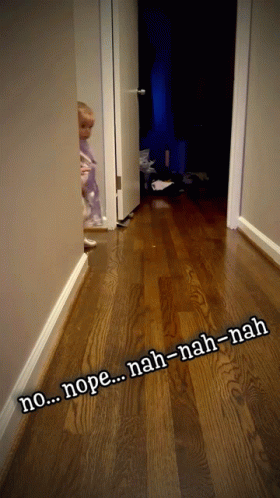 A Child Standing In A Hallway With The Words Nope Nah-Nah-Nah Written On The Floor GIF