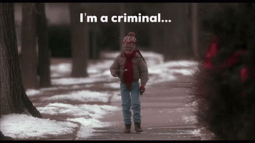 A Child Walking Down A Snowy Sidewalk With The Words " I 'M A Criminal " Behind Him GIF