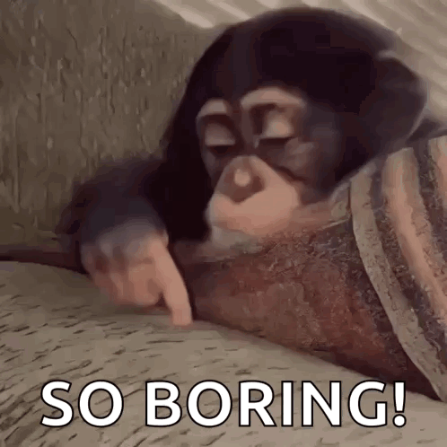 A Chimpanzee Is Laying On A Bed With Its Eyes Closed And Pointing At Something . GIF