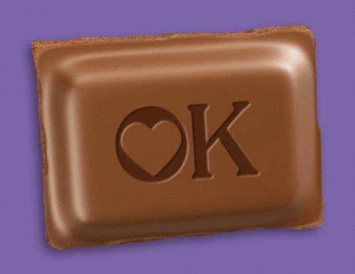 A Chocolate Bar With The Letters Ok And A Heart On It GIF