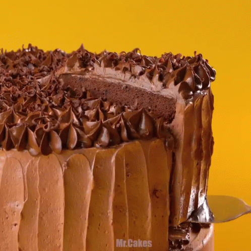 A Chocolate Cake With A Slice Taken Out Of It And The Words Mr.cakes On The Bottom GIF
