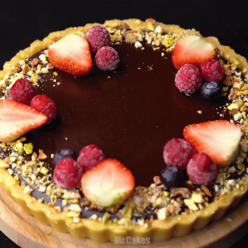 a chocolate cake with strawberries raspberries and blueberries