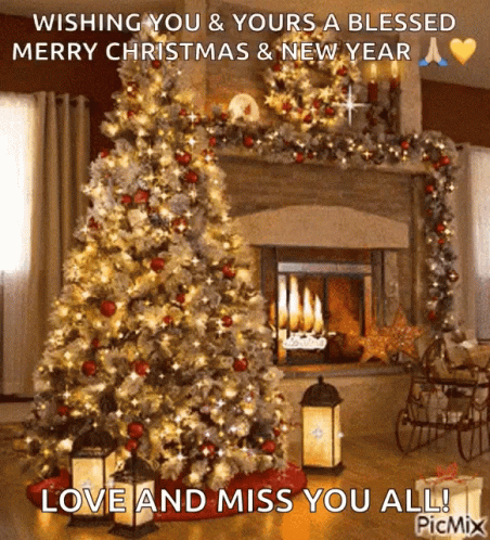 A Christmas Tree In Front Of A Fireplace With The Words Wishing You & Yours A Blessed Merry Christmas And New Year GIF
