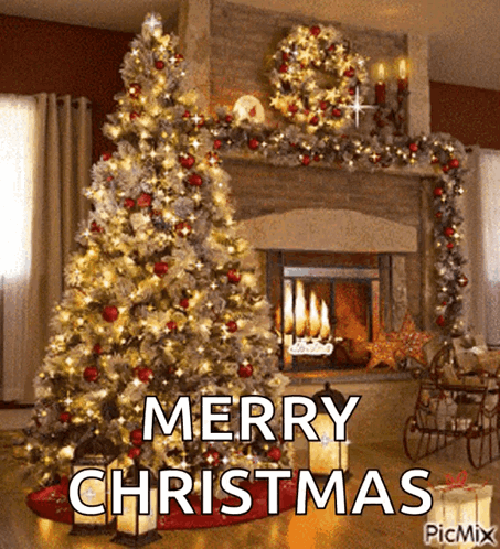 A Christmas Tree Is In Front Of A Fireplace With The Words Merry Christmas Written On It GIF