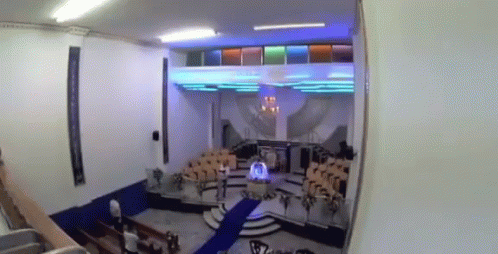 A Church With A Blue Carpet And A Podium In The Middle GIF
