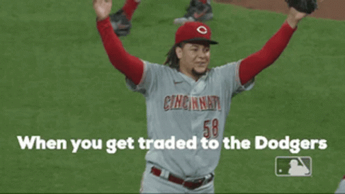 a cincinnati baseball player is holding his arms in the air