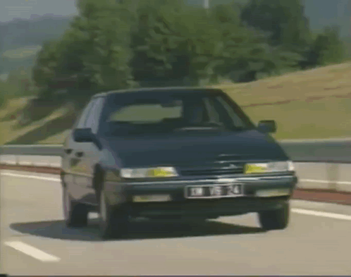 A Citroen Car Is Driving Down A Highway With A License Plate That Says Jm T14 GIF