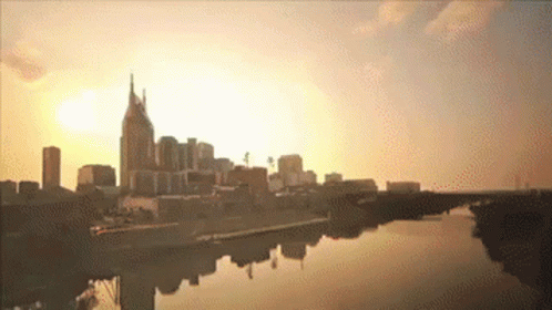 a city skyline with a river in the foreground