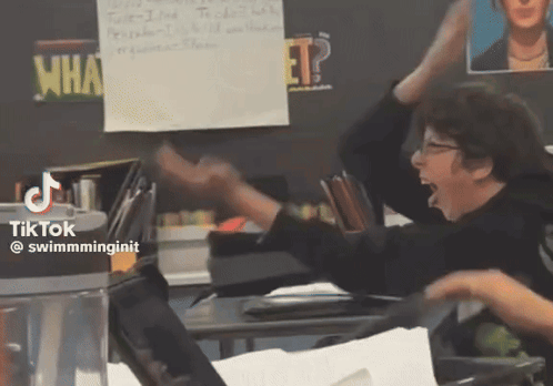 A Classroom With A Sign That Says What GIF
