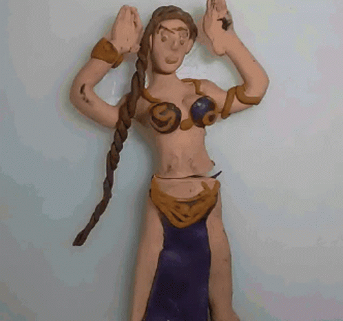 A Clay Figure Of A Woman With Braids And A Purple Skirt GIF
