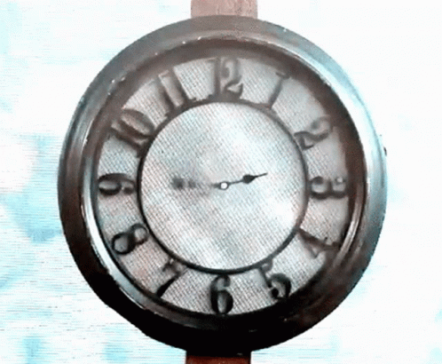 A Clock That Has The Hands On The Numbers 1 And 12 GIF