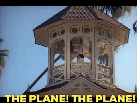 A Clock Tower With The Words " The Plane The Plane " Above It GIF
