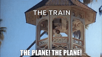A Clock Tower With The Words `` The Train The Plane ! The Plane ! '' Written On It . GIF