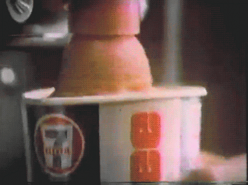 A Close Up Of A 7 Eleven Cup With A Cube In It GIF