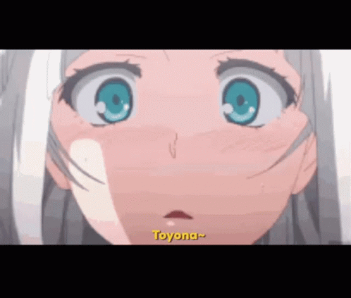 A Close Up Of A Anime Girl 'S Face With Blue Eyes And The Word Toyona Written In Yellow . GIF