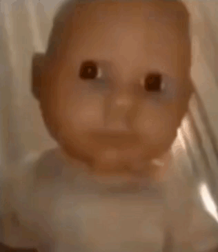 A Close Up Of A Baby Doll In A Glass Jar . GIF