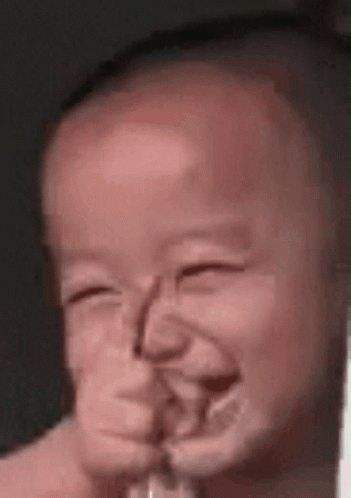 A Close Up Of A Baby Making A Funny Face GIF