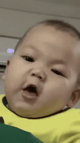 A Close Up Of A Baby Making A Funny Face With His Mouth Open . GIF