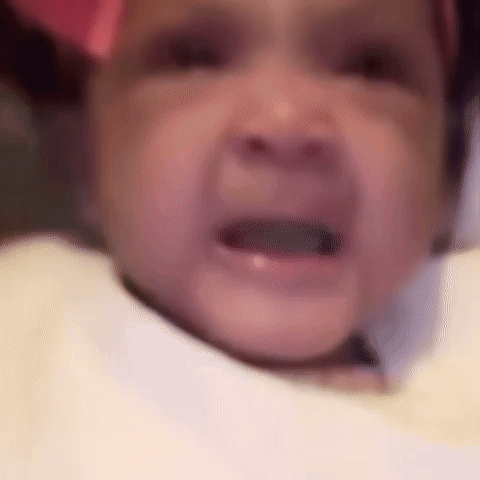 A Close Up Of A Baby 'S Face With A Pink Bow On It . GIF