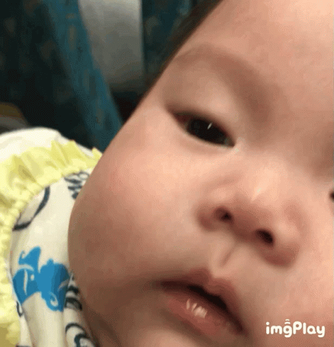 A Close Up Of A Baby 'S Face With The Words Imgplay Below GIF