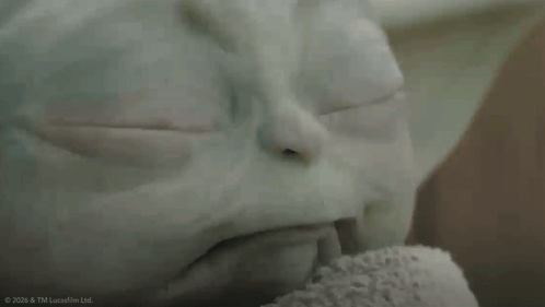 A Close Up Of A Baby Yoda From Star Wars Looking At The Camera GIF