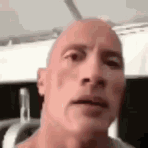 A Close Up Of A Bald Man 'S Face . GIF