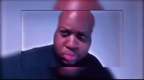 A Close Up Of A Bald Man 'S Face With A Blue Background Behind Him . GIF