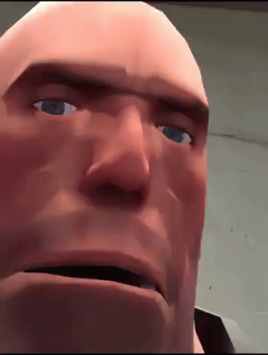 A Close Up Of A Bald Man 'S Face With Blue Eyes And A Serious Look On His Face . GIF