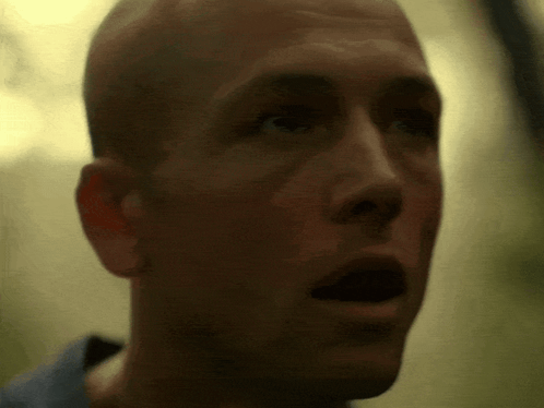 A Close Up Of A Bald Man 'S Face With His Mouth Open GIF