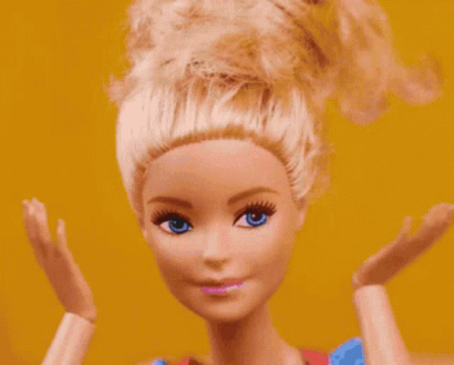 A Close Up Of A Barbie Doll 'S Face With Blue Eyes GIF