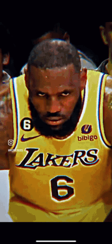 A Close Up Of A Basketball Player Wearing A Yellow Lakers Jersey . GIF